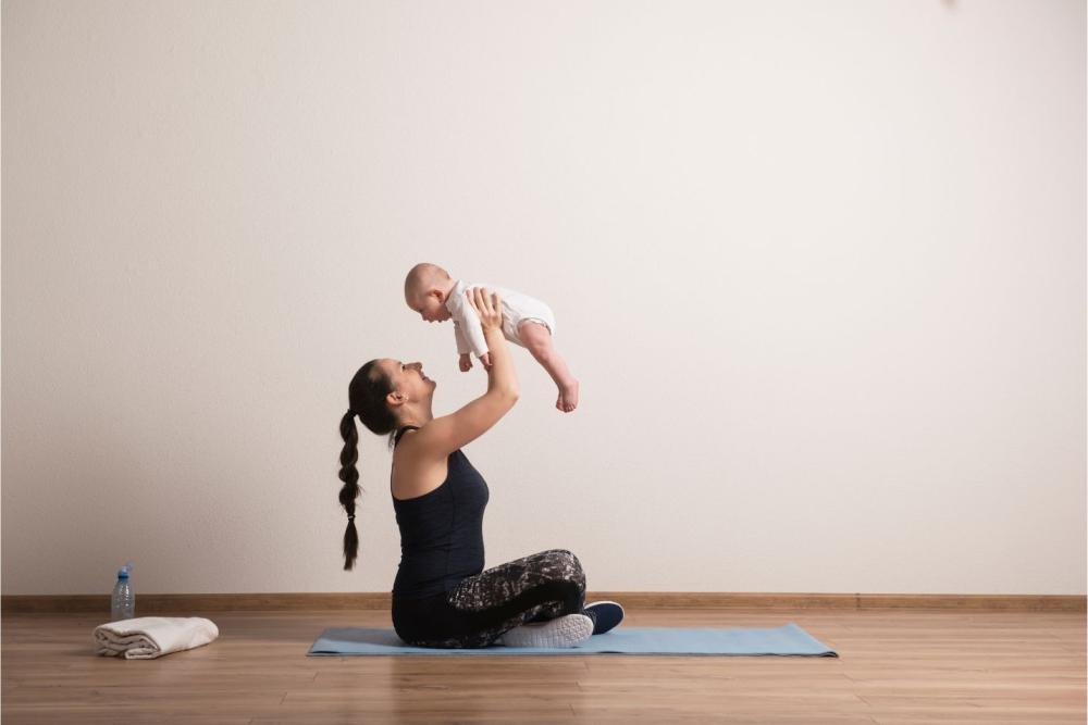 Postpartum Pelvic Health mom holding baby